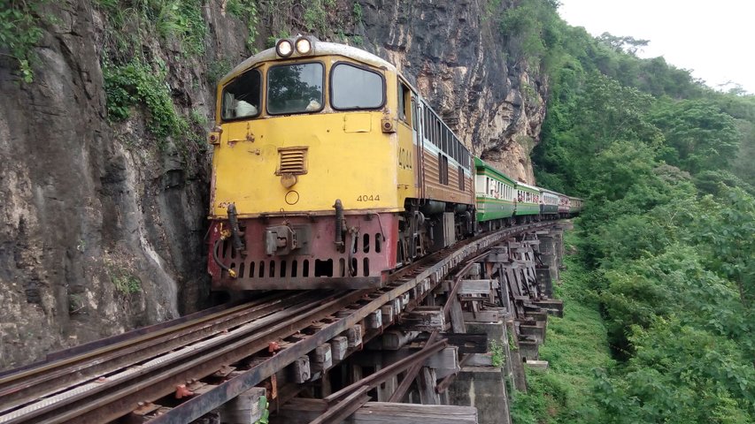 Zug bei der Fahrt entlang der steilen Hänge am River Kwai